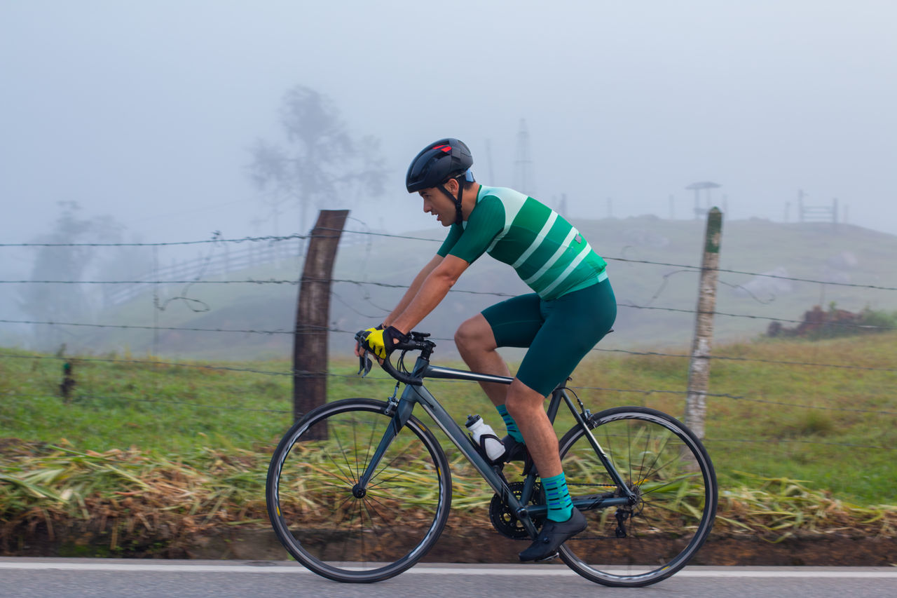 lifestyle concept. cyclist on the road training. general plan. cloudy day Rugby team, people and coaching strategy, checklist and game event, formation or match planning at stadium. Happy diversity group, sports men and training manager for goals, discussion and mission;